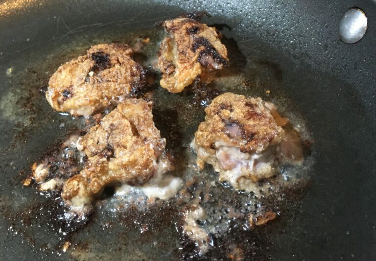 Four lake whitefish livers in a frying pan.